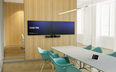 A boardroom set up with dual TVs for video conferencing