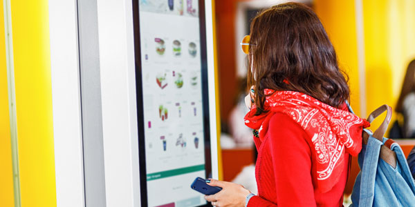 A student ordering lunch on an interactive display from Data Projections