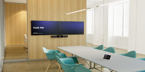 A boardroom set up with dual TVs for video conferencing