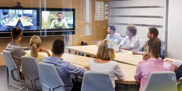 A team on a conference call with a client using Data Projections conference solutions